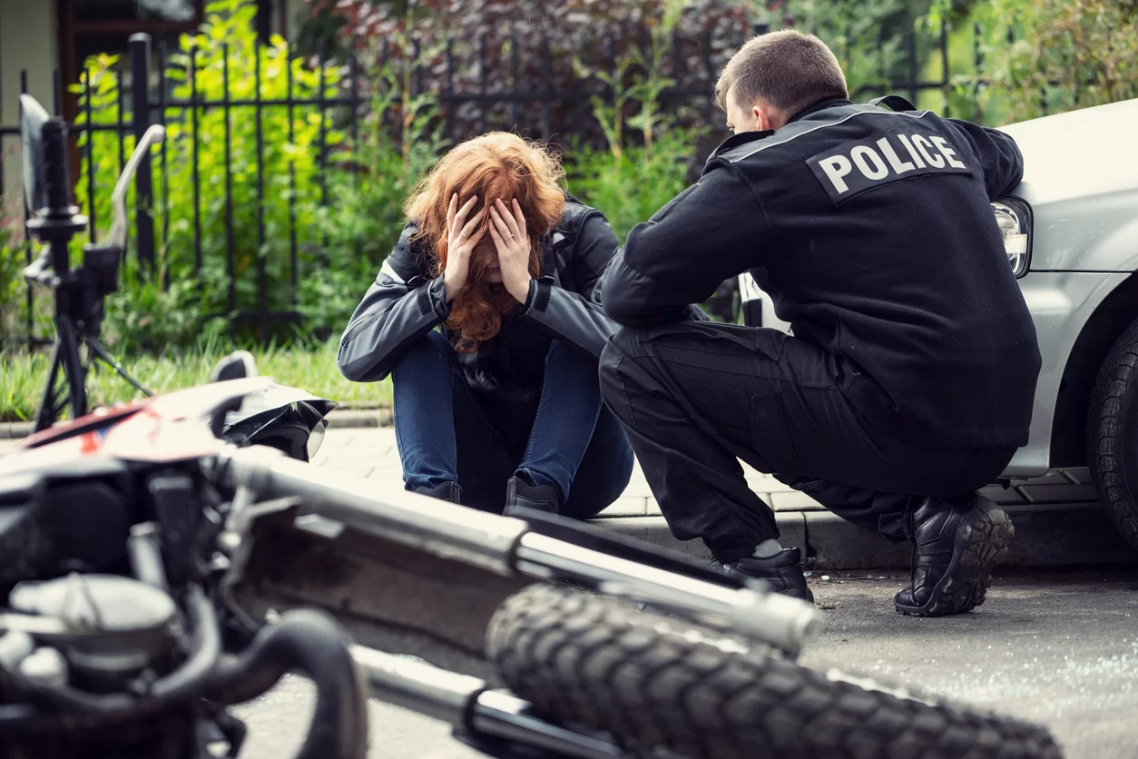 Victim of a traffic collision of motorcycle with a car and policeman